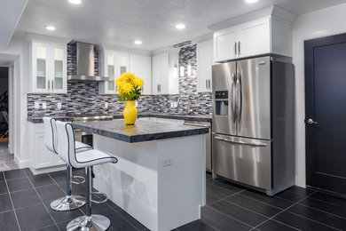 Example of a mid-sized arts and crafts gray floor eat-in kitchen design in Salt Lake City with a drop-in sink, shaker cabinets, white cabinets, gray backsplash, stainless steel appliances, an island and gray countertops