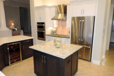 Example of a large trendy ceramic tile and beige floor open concept kitchen design in Miami with an undermount sink, shaker cabinets, white cabinets, quartzite countertops, gray backsplash, glass tile backsplash, stainless steel appliances and an island
