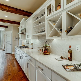 Mid-sized contemporary open concept kitchen inspiration - Open concept kitchen - mid-sized contemporary l-shaped medium tone wood floor and brown floor open concept kitchen idea in Richmond with a farmhouse sink, shaker cabinets, white cabinets, quartzite countertops, white backsplash, subway tile backsplash, stainless steel appliances and an island