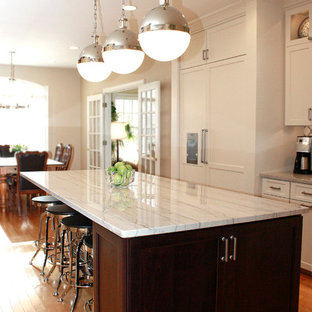 Contemporary eat-in kitchen ideas - Inspiration for a contemporary l-shaped eat-in kitchen remodel in Philadelphia with a farmhouse sink, shaker cabinets, white cabinets, quartzite countertops, white backsplash and stainless steel appliances