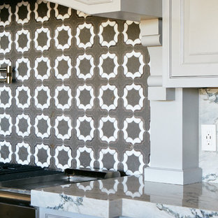 Large transitional open concept kitchen designs - Example of a large transitional medium tone wood floor and brown floor open concept kitchen design in Other with a farmhouse sink, raised-panel cabinets, white cabinets, quartzite countertops, gray backsplash, mosaic tile backsplash, stainless steel appliances, an island and white countertops