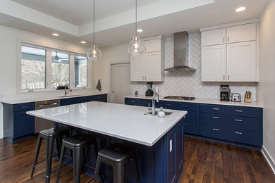 Kitchen - modern medium tone wood floor and brown floor kitchen idea in Other with an undermount sink, shaker cabinets, blue cabinets, quartz countertops, white backsplash, subway tile backsplash, stainless steel appliances, an island and white countertops