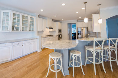 Large light wood floor kitchen photo in Philadelphia with an undermount sink, marble countertops, white backsplash and stainless steel appliances