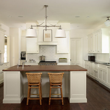 White painted kitchen with wood and stainless sell countertops