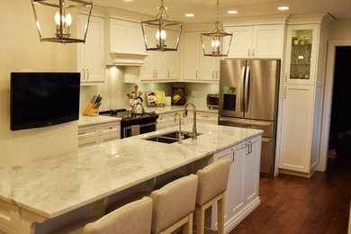 Example of a transitional kitchen design in Other with an undermount sink, stainless steel appliances, an island and white countertops