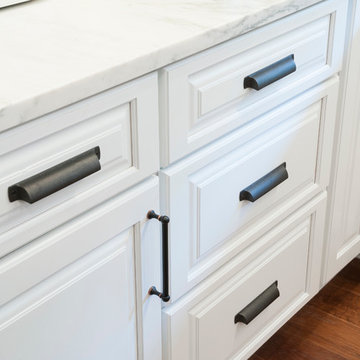 White raised panel cabinets with oil rubbed bronze hardware