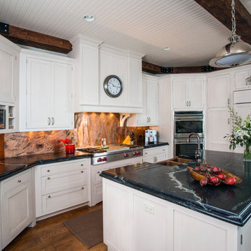 White Recessed Panel Cabinet Kitchen with Bead Board and Distressed Beam Ceiling