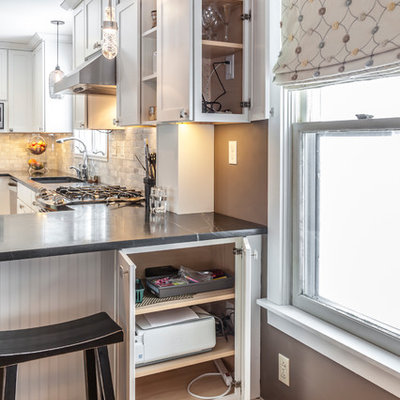 Example of a mid-sized arts and crafts u-shaped light wood floor eat-in kitchen design in Burlington with an undermount sink, shaker cabinets, white cabinets, soapstone countertops, white backsplash, stone tile backsplash, stainless steel appliances and an island