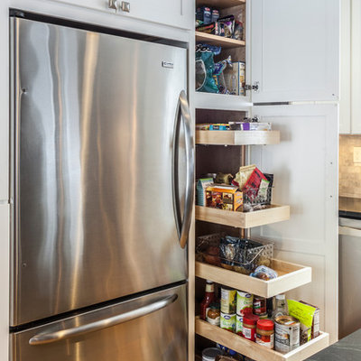 Inspiration for a mid-sized craftsman light wood floor kitchen pantry remodel in Burlington with an undermount sink, shaker cabinets, white cabinets, soapstone countertops, stainless steel appliances and an island
