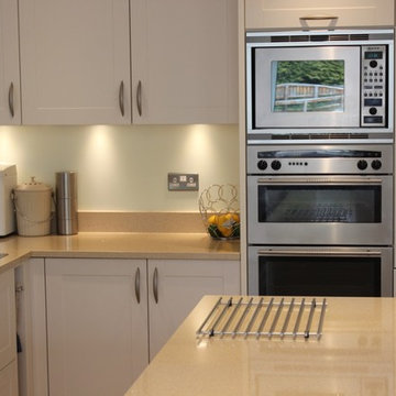 White shaker kitchen with stainless steel appliances