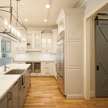 White Transitional Kitchen Featuring Double Islands and Custom Barn Doors