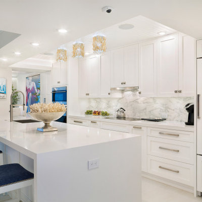 Large trendy single-wall porcelain tile and white floor open concept kitchen photo in Miami with an undermount sink, shaker cabinets, white cabinets, marble countertops, multicolored backsplash, marble backsplash, stainless steel appliances, an island and white countertops