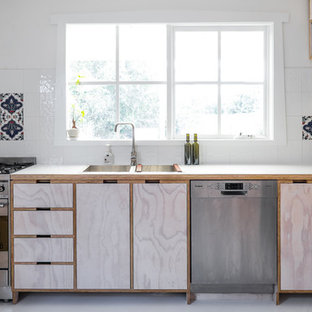 Inspiration for a contemporary l-shaped kitchen in Melbourne with a drop-in sink, beaded inset cabinets, light wood cabinets, white splashback and stainless steel appliances.