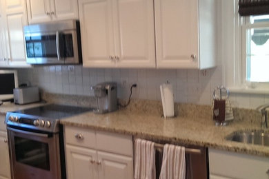Example of a kitchen design in Cincinnati with shaker cabinets and white cabinets