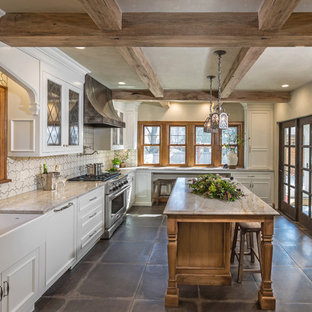 Mid-sized traditional l-shaped separate kitchen in Milwaukee with a farmhouse sink, recessed-panel cabinets, white cabinets, marble benchtops, white splashback, cement tile splashback, panelled appliances, porcelain floors, with island, grey floor and multi-coloured benchtop.
