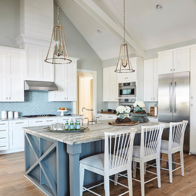 Inspiration for a cottage u-shaped medium tone wood floor and brown floor kitchen remodel in Atlanta with shaker cabinets, blue backsplash, stainless steel appliances, an island and white cabinets