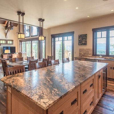 Example of a large mountain style l-shaped dark wood floor and blue floor open concept kitchen design in Boise with an undermount sink, recessed-panel cabinets, light wood cabinets, granite countertops, beige backsplash, terra-cotta backsplash, paneled appliances, an island and gray countertops
