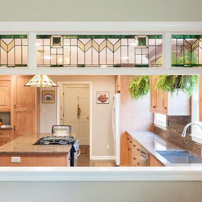 Mid-sized arts and crafts l-shaped medium tone wood floor eat-in kitchen photo in Indianapolis with an undermount sink, shaker cabinets, medium tone wood cabinets, granite countertops, multicolored backsplash, stone tile backsplash, stainless steel appliances and an island