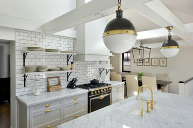 Example of a transitional galley medium tone wood floor eat-in kitchen design in Toronto with recessed-panel cabinets, gray cabinets, marble countertops, white backsplash, subway tile backsplash, black appliances, an island and an undermount sink