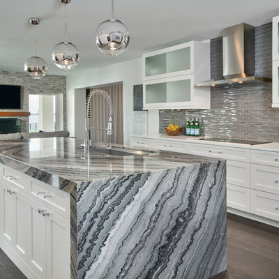 Inspiration for a mid-sized contemporary galley dark wood floor and brown floor open concept kitchen remodel in Tampa with an undermount sink, shaker cabinets, white cabinets, glass tile backsplash, stainless steel appliances, marble countertops, gray backsplash and an island