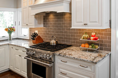 Inspiration for a large transitional l-shaped dark wood floor and brown floor eat-in kitchen remodel in Philadelphia with a farmhouse sink, beaded inset cabinets, white cabinets, granite countertops, gray backsplash, subway tile backsplash, stainless steel appliances, an island and white countertops