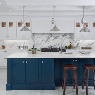Example of a mid-sized transitional l-shaped light wood floor and white floor kitchen design in Other with an undermount sink, shaker cabinets, quartzite countertops, gray backsplash, marble backsplash, stainless steel appliances, an island and blue cabinets