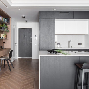 Inspiration for a contemporary kitchen in London with light hardwood floors and pink floor.