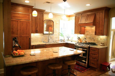 Kitchen - mid-sized transitional l-shaped medium tone wood floor kitchen idea in San Diego with an undermount sink, shaker cabinets, medium tone wood cabinets, granite countertops, beige backsplash, brick backsplash and an island