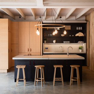 Medium sized contemporary single-wall kitchen in Cornwall with a submerged sink, raised-panel cabinets, light wood cabinets, concrete worktops, grey splashback, ceramic splashback, stainless steel appliances, concrete flooring, an island, grey floors and grey worktops.
