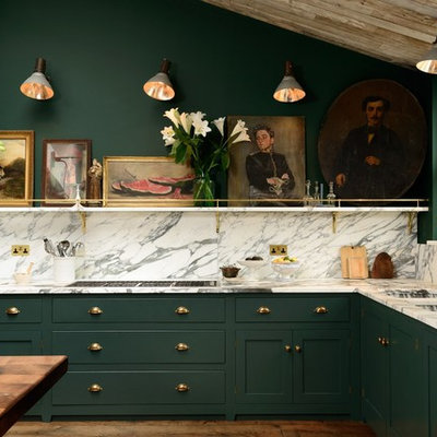 Inspiration for a mid-sized timeless l-shaped medium tone wood floor kitchen remodel in London with shaker cabinets, green cabinets, multicolored backsplash and a double-bowl sink