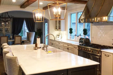 Example of a mid-sized mountain style single-wall medium tone wood floor and brown floor enclosed kitchen design in Chicago with a farmhouse sink, shaker cabinets, white cabinets, marble countertops, white backsplash, subway tile backsplash, an island and white countertops