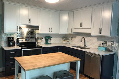 Mid-sized trendy l-shaped laminate floor and brown floor kitchen pantry photo in Louisville with an undermount sink, shaker cabinets, blue cabinets, solid surface countertops, white backsplash, porcelain backsplash, stainless steel appliances and an island