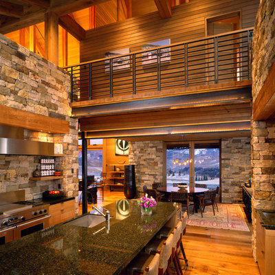 Eat-in kitchen - large rustic medium tone wood floor eat-in kitchen idea in Denver with stainless steel appliances, an undermount sink, flat-panel cabinets, light wood cabinets, granite countertops, gray backsplash, stone tile backsplash and an island