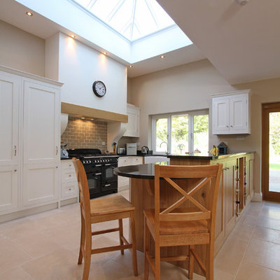 Example of a trendy kitchen design in Hampshire with shaker cabinets and black appliances