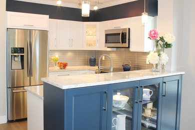 Example of a transitional kitchen design in Vancouver with shaker cabinets, white cabinets and quartz countertops