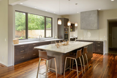 Trendy dark wood floor kitchen photo in Seattle with flat-panel cabinets, dark wood cabinets, white backsplash and an island