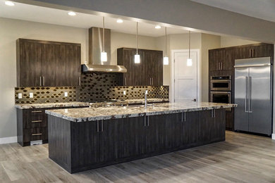 Large trendy galley porcelain tile and gray floor open concept kitchen photo in Las Vegas with shaker cabinets, dark wood cabinets, granite countertops, ceramic backsplash, stainless steel appliances, an island and an undermount sink