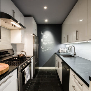 Mid-sized midcentury galley eat-in kitchen in New York with an undermount sink, flat-panel cabinets, white cabinets, concrete benchtops, white splashback, stone tile splashback, stainless steel appliances, marble floors and no island.