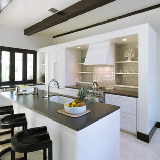Transitional kitchen appliance - Example of a transitional kitchen design in Charleston with an undermount sink, open cabinets, white cabinets, beige backsplash, subway tile backsplash, stainless steel appliances and an island