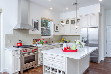 Mid-sized transitional l-shaped dark wood floor eat-in kitchen photo in San Francisco with an undermount sink, raised-panel cabinets, white cabinets, quartz countertops, green backsplash, ceramic backsplash, stainless steel appliances and an island
