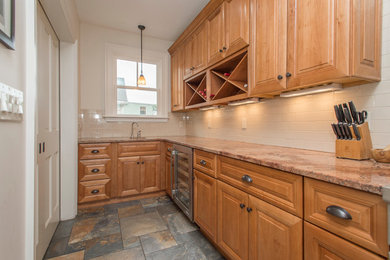 Example of a mid-sized transitional ceramic tile enclosed kitchen design in Boston with a farmhouse sink, medium tone wood cabinets, granite countertops, beige backsplash, ceramic backsplash, stainless steel appliances and no island