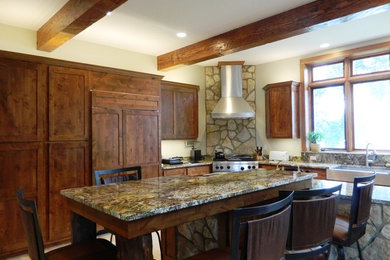 Mountain style eat-in kitchen photo in Other with dark wood cabinets, granite countertops and stainless steel appliances