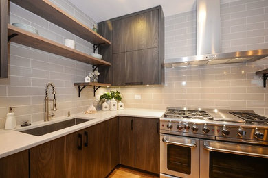 Large trendy l-shaped medium tone wood floor and brown floor eat-in kitchen photo in Chicago with an undermount sink, flat-panel cabinets, medium tone wood cabinets, quartz countertops, gray backsplash, subway tile backsplash, stainless steel appliances and an island