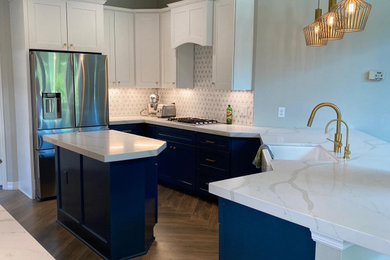Imagen de cocina minimalista de tamaño medio con armarios estilo shaker, puertas de armario azules y una isla