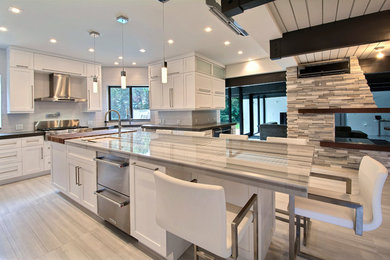 Example of a large trendy u-shaped kitchen design in Miami with open cabinets, white cabinets, granite countertops, white backsplash, ceramic backsplash, stainless steel appliances and an island