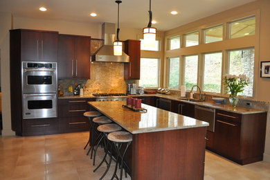 Large trendy u-shaped ceramic tile and beige floor kitchen photo in New York with an undermount sink, flat-panel cabinets, dark wood cabinets, granite countertops, brown backsplash, stone slab backsplash, stainless steel appliances and an island