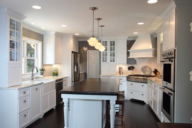 Eat-in kitchen - mid-sized traditional u-shaped dark wood floor eat-in kitchen idea in Milwaukee with a farmhouse sink, shaker cabinets, white cabinets, onyx countertops, stone slab backsplash, stainless steel appliances, an island and white backsplash