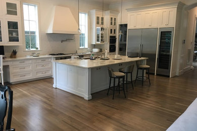 Inspiration for a contemporary medium tone wood floor kitchen remodel in Houston