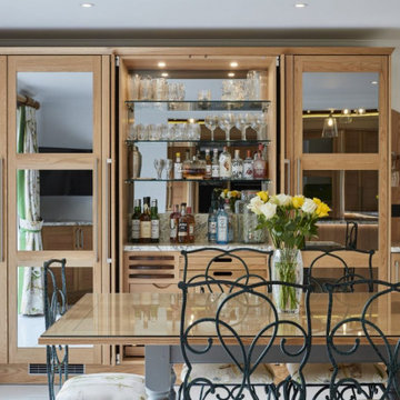Wooden oak kitchen with green glass splashback