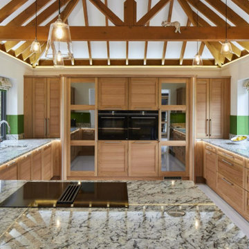 Wooden oak kitchen with green glass splashback